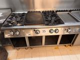 stainless steel stove top with four burners and three burners