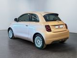 the small car is parked in the large room of the showroom