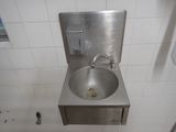 a stainless steel sink in a public restroom