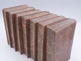 six books stacked on top of each other on a white surface