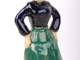 a figurine of a woman wearing a green skirt