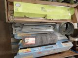 a pile of assorted items sitting on top of a wooden shelf