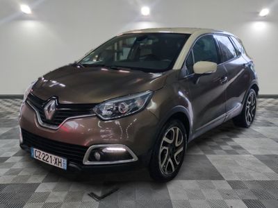 the front of a brown car is parked on a checkered floor