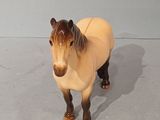 a small toy horse that is standing on the floor