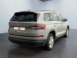the rear end of a silver suv parked in a showroom