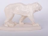a white statue of a tiger on a white surface