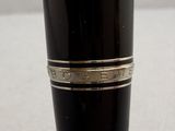 a close up of a black pen with a silver band