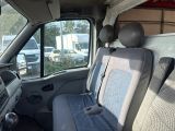 a dog that is sitting in the back seat of a van