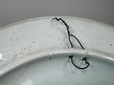 a close up of a toilet bowl with a wire on it