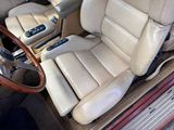 beige leather seats in a car with a steering wheel and dashboard controls