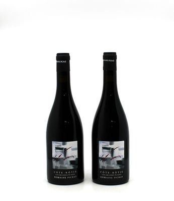 two bottles of wine sitting next to each other on a white surface