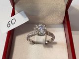 a diamond ring in a red box with a price tag