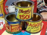 three tins of food sitting on a table