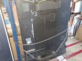 a black refrigerator with a chain around it in a garage