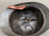 a metal helmet with a leather strap on it