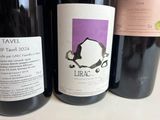 several bottles of wine are lined up on a table
