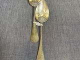 three spoons that are sitting on a table