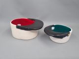 two bowls that are sitting side by side on a table