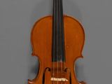 an old violin with a bow hanging on a wall