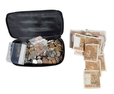 a black case filled with coins and notes on a white background