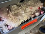 a dog that is laying in a box with ornaments