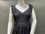 black silk dress with ruffles and pleas on mannequin torso