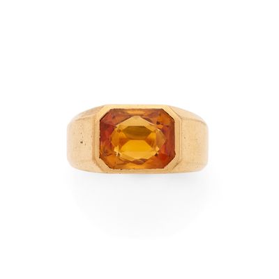 une bague en or jaune sertie d'une topaze orange