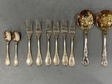 a lot of silver spoons and forks on the table