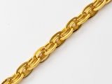 a close up of a gold chain on a white surface