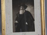 an old photo of a man with a long beard and a hat