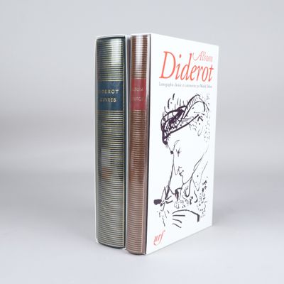 two books sitting on top of each other on a white surface