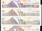 plusieurs billets sur lesquels figure la photo d'un homme en costume-cravate