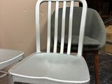 a white chair sitting next to a table in a room