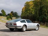 a white sports car parked on the side of the road