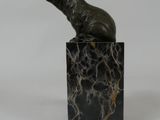 statue of a seal sitting on a marble block on a white background