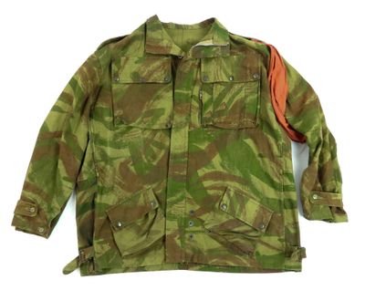 an image of a military jacket with a red patch on the chest