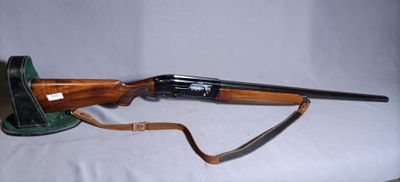 an old rifle with a wooden barrel and a leather case