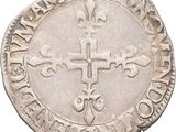 a close up of a coin with a cross on it