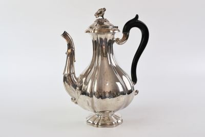 an antique silver tea pot with a black handle on a white background