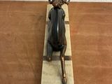 statue of a bull with horns on a block on a wooden table