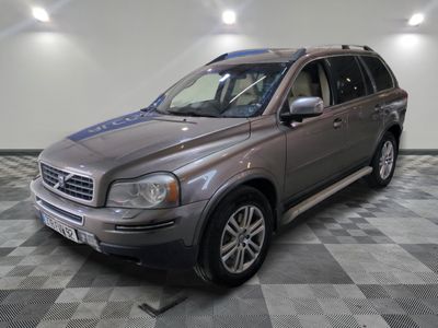 a picture of a silver volvo suv parked in a garage