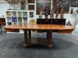 une grande table à manger ovale au milieu d'une pièce