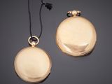 two gold - plated pocket watches, one with a chain and the other with a clasp