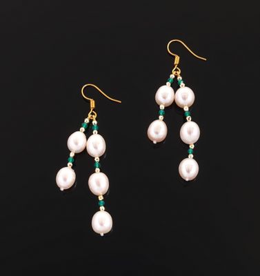 a pair of earrings with pearls and emerald beads