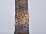 an image of a tall metal object with a brown patt on it
