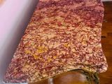 a table with a marble top on a hard wood floor