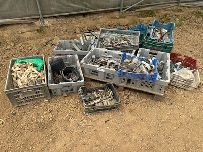 un tas d'objets divers rangés dans des caisses posées par terre