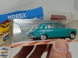 a person holding a toy car in front of a box