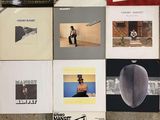a lot of different album covers on the wall