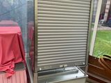 a refrigerator that is sitting in the corner of a room